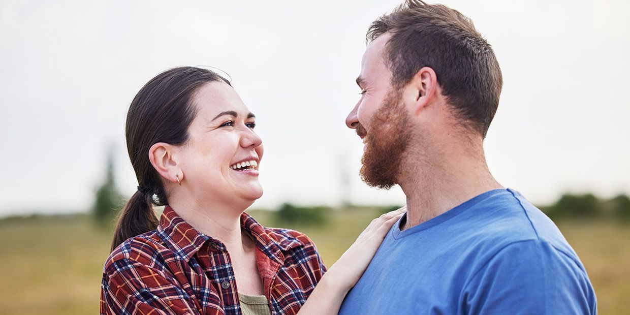 Happy couple enjoying a moment together in nature after a love psychic reading session.