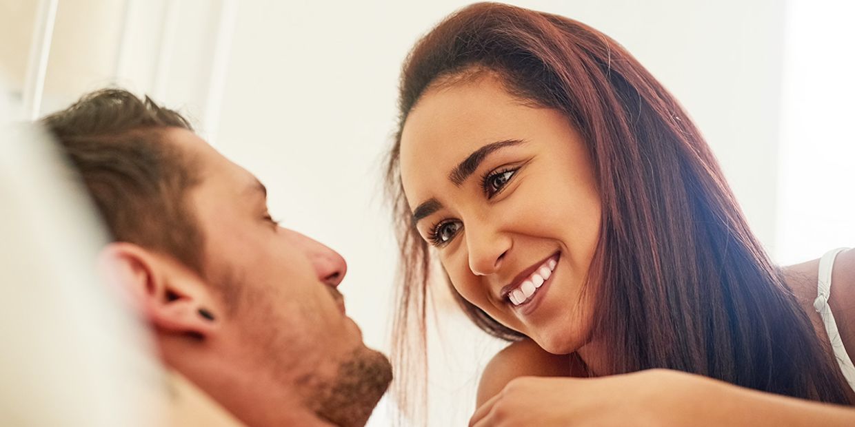 Couple sharing intimate gaze, exploring feelings of love and connection.