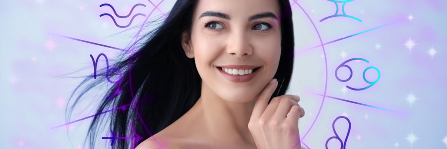 A woman standing in front of zodiac signs