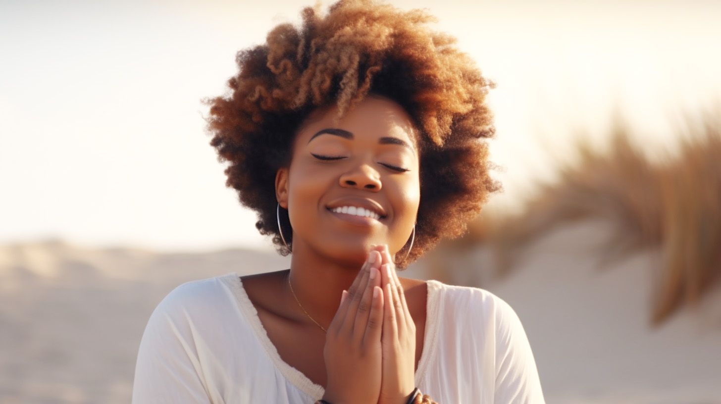 A woman praying on a beach