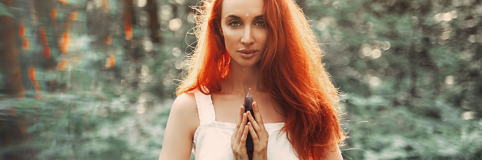 A spiritual lady holding a crystal.