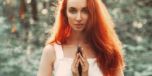 A spiritual lady holding a crystal.