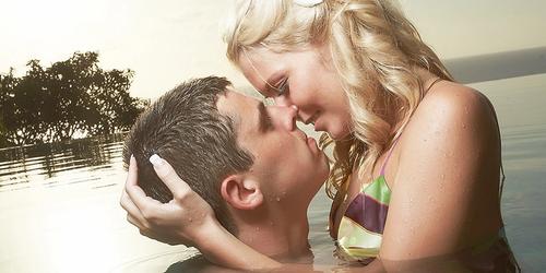A couple kissing in the ocean