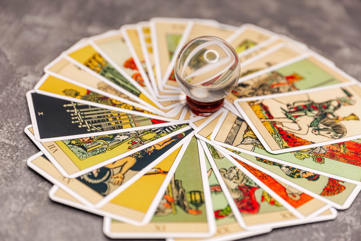 A circle of tarot cards with a crystal ball on top