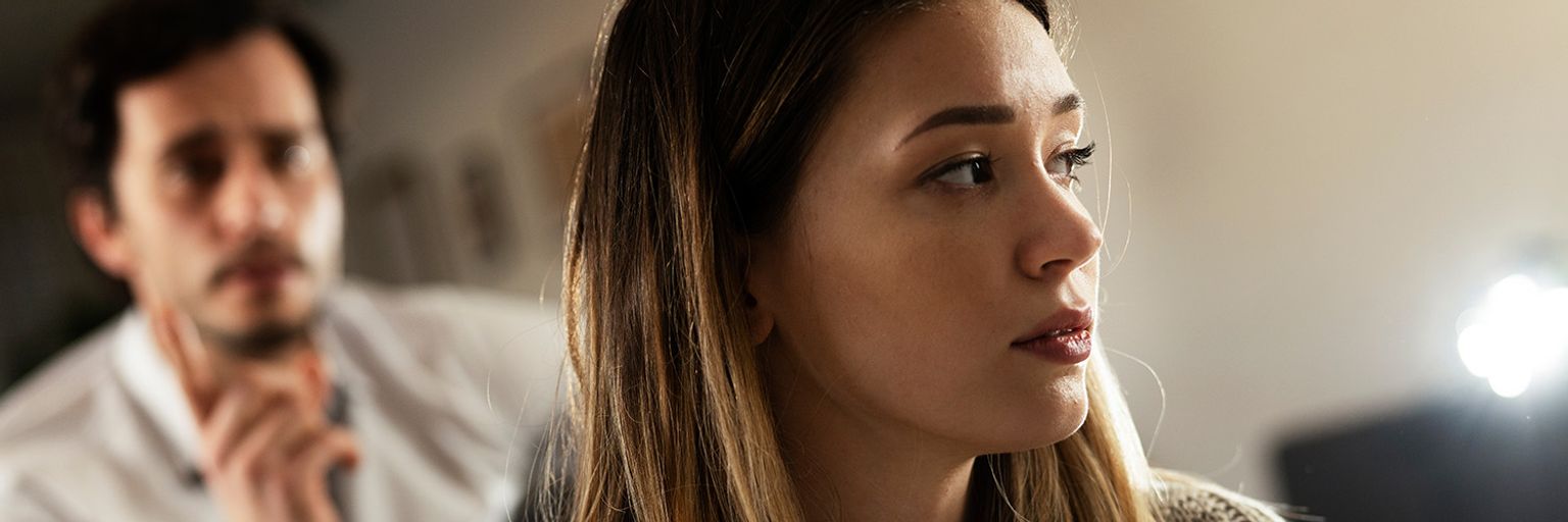 A frustrated wife listening to her husband.