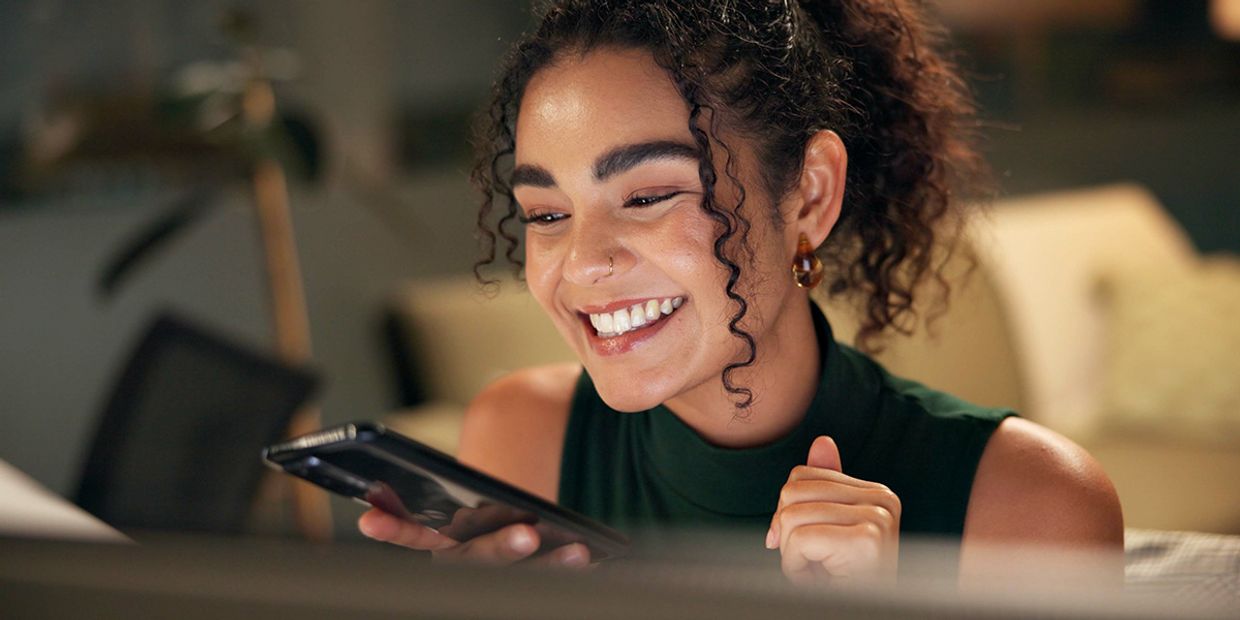 A happy female in her 20s, speaking on her mobile phone.