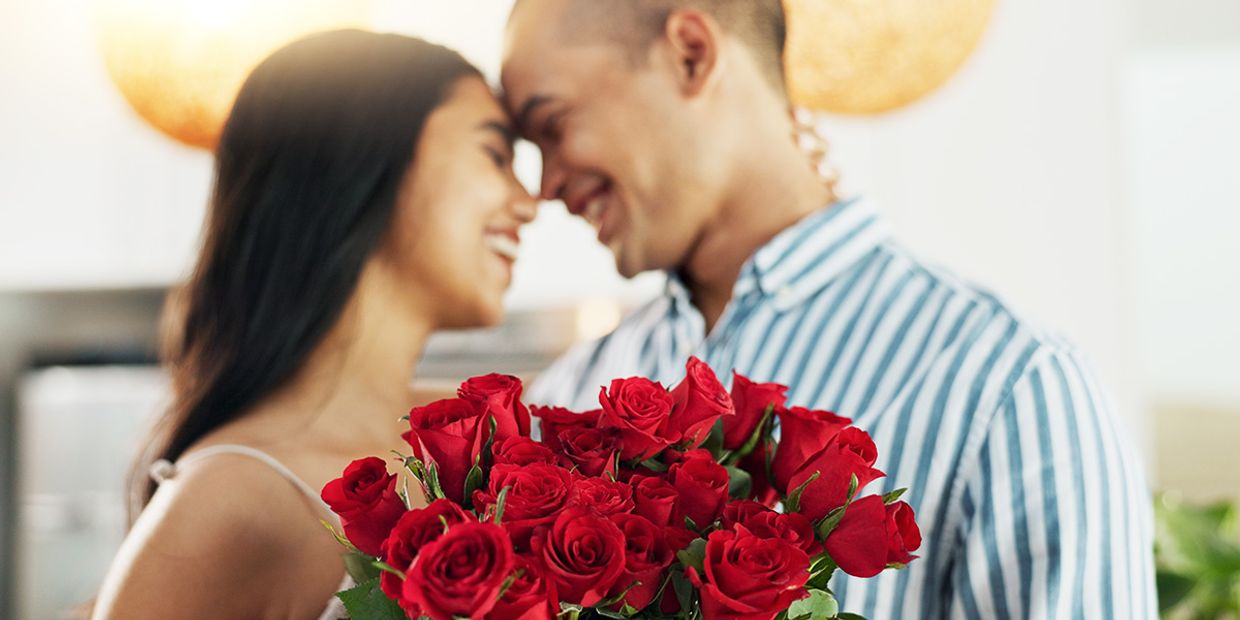 Couple sharing a romantic moment with roses, showing love and loyalty.