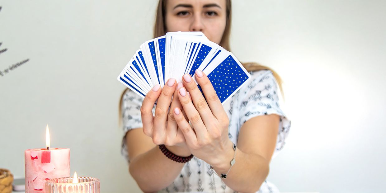How to Find the Best Psychic Reading Online - A professional tarot card reader, holding her tarot cards.