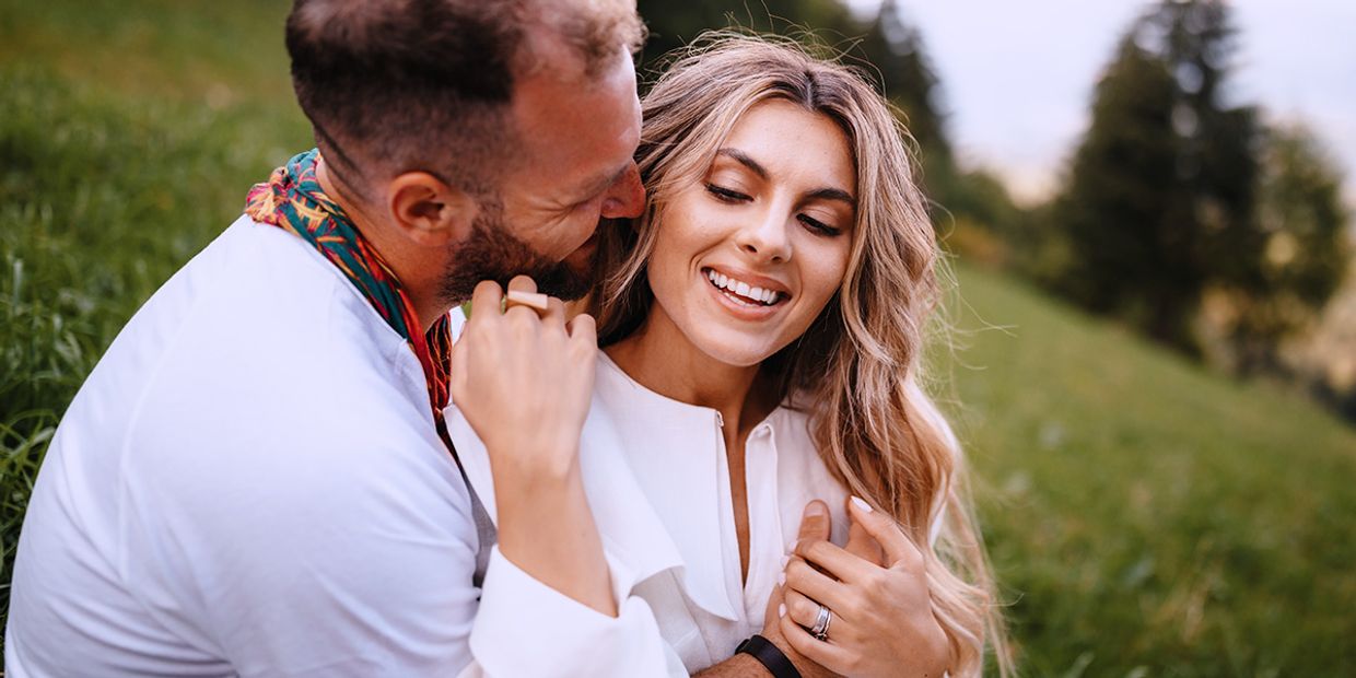 A young couple deeply in love, embracing each other in the park.