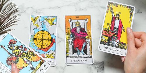 A woman holding tarot cards