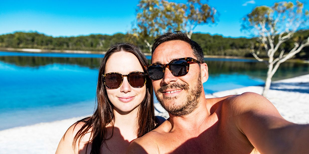A couple enjoying a beautiful day by the water, symbolising love and happiness.