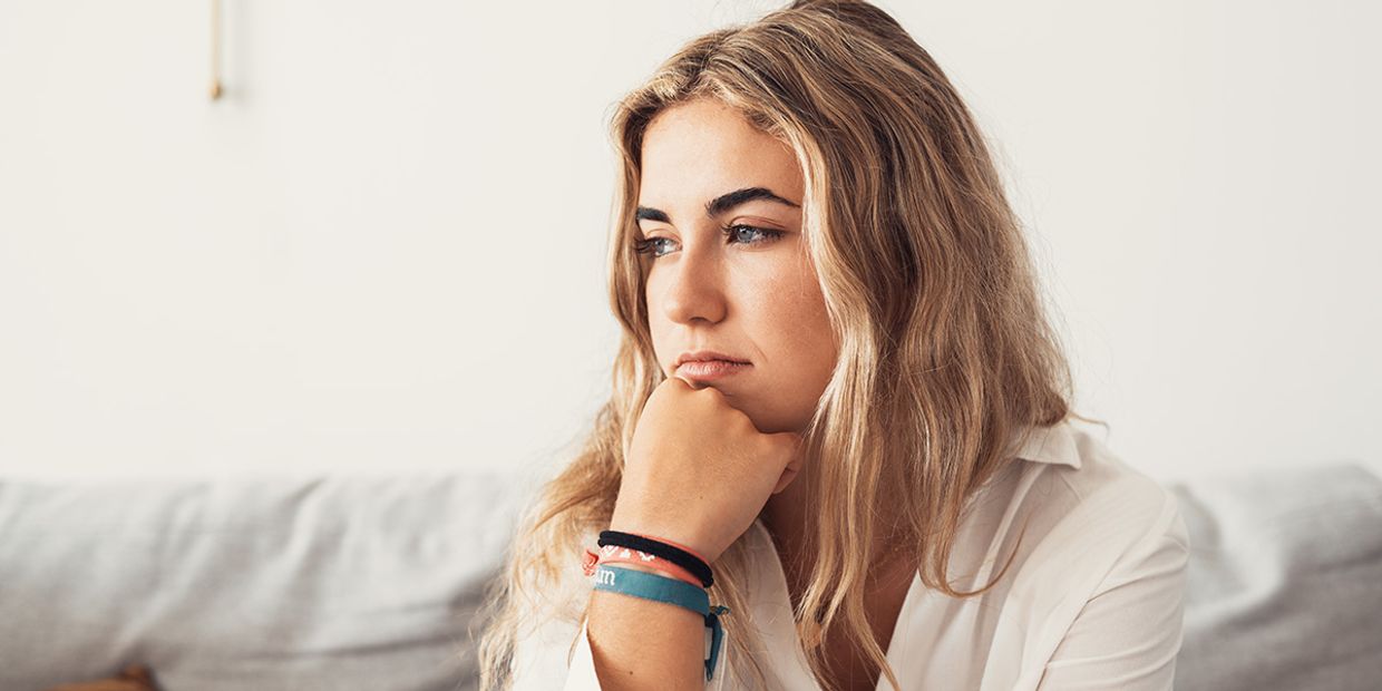 A concerned woman deep in thought, reflecting on signs of infidelity.