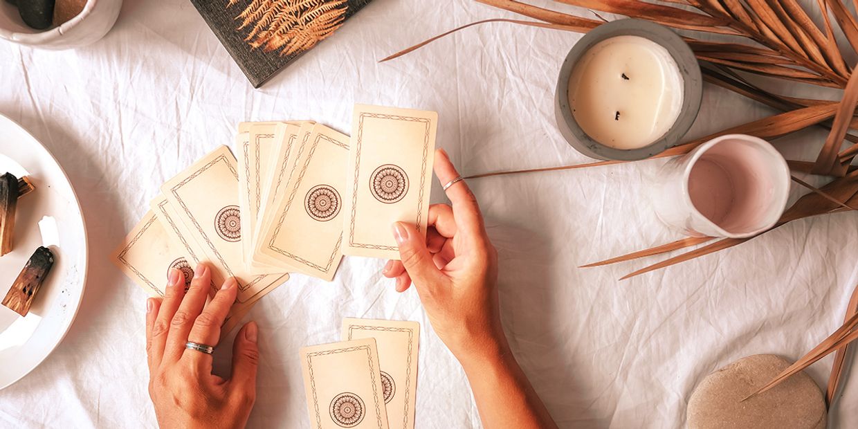 A tarot reader doing a tarot card reading in her living room.