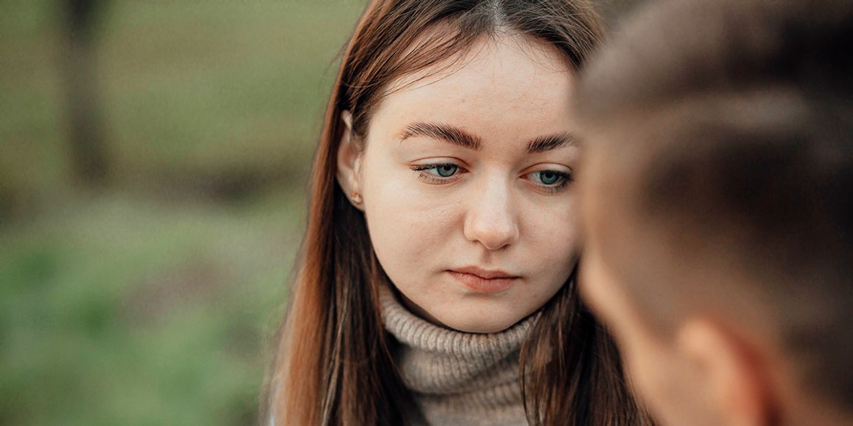 Contemplative young woman reflecting on her past relationship with an ex.