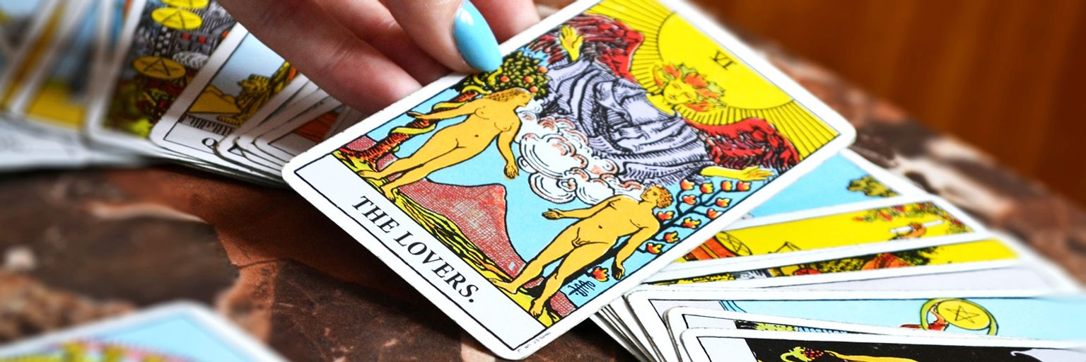 A Tarot card featuring 'The Lovers' from a Tarot deck for reconciliation guidance.