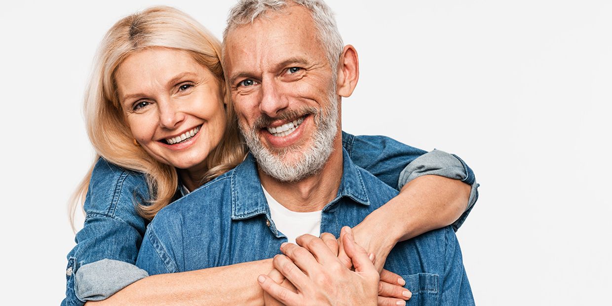 An older couple very much in love, embracing each other.