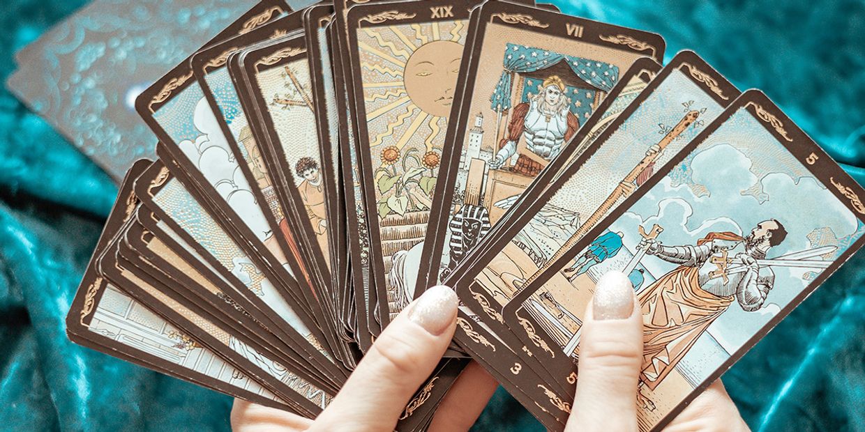 A lady holding a tarot spread