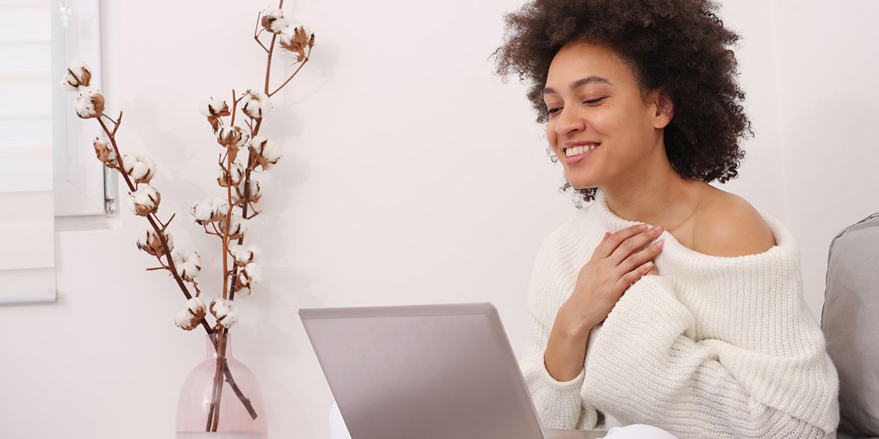 A woman seeking deeper emotional connection, whilst looking at her laptop.
