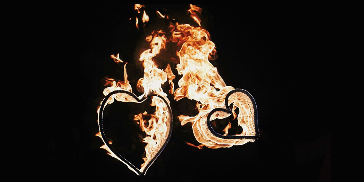 A Twin Flame love concept, two love hearts in flames.