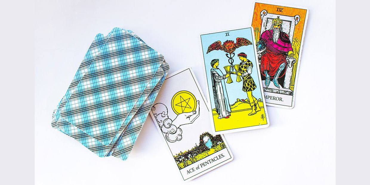 Ace of Pentacles, Two of Cups, and Emperor tarot cards are on a white backdrop, symbolising new beginnings, relationships, and power.