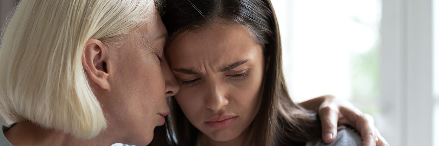 A woman supporting another woman with mental health issues.