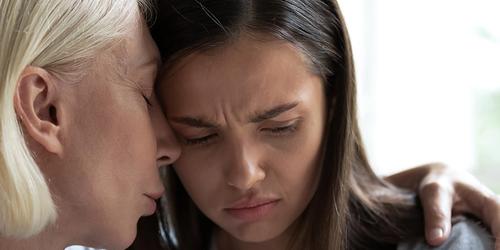 A woman supporting another woman with mental health issues.