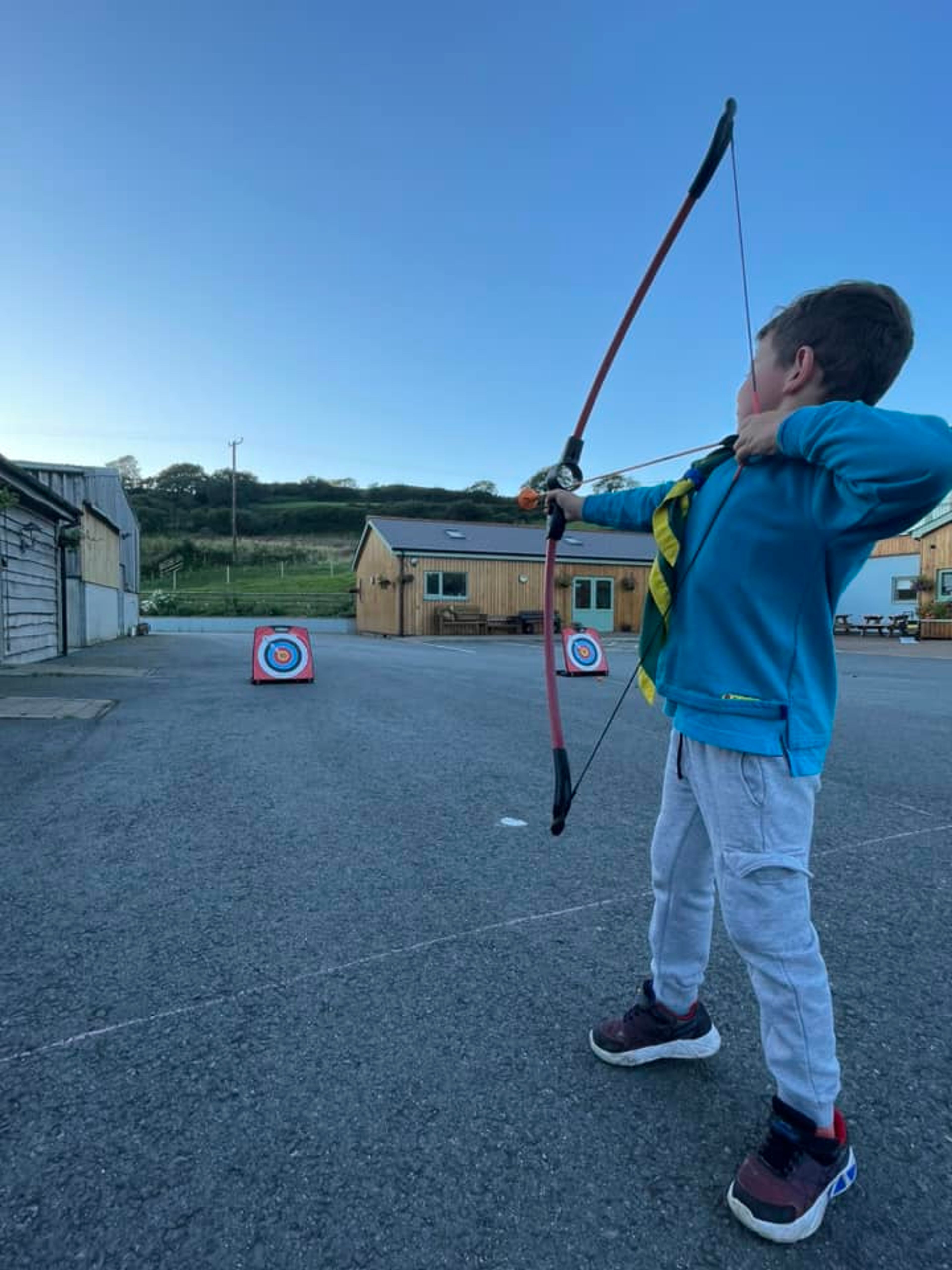 A beaver using a bow and arrow