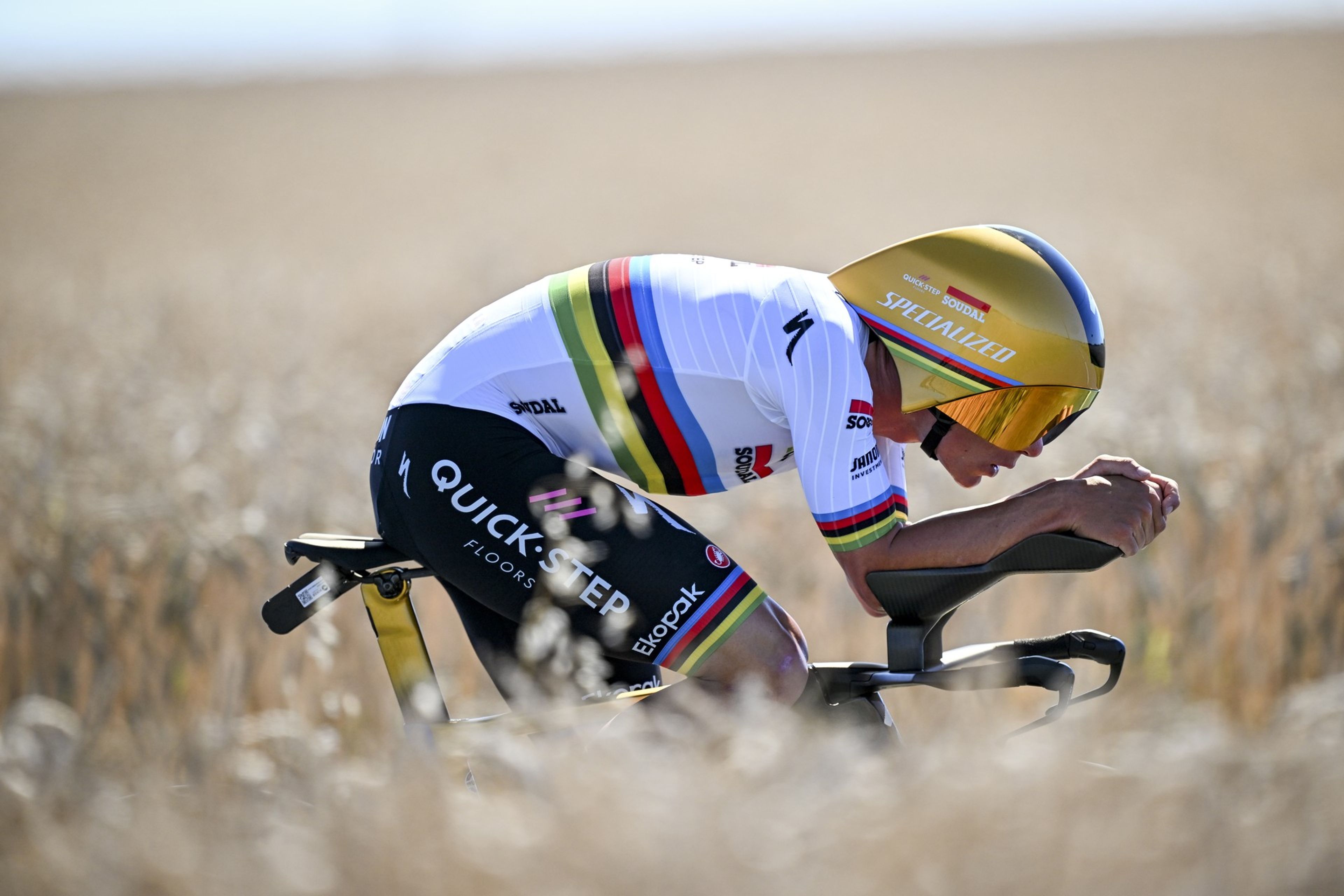 Low-angle shot of Evenepoel low aero TT position in fields