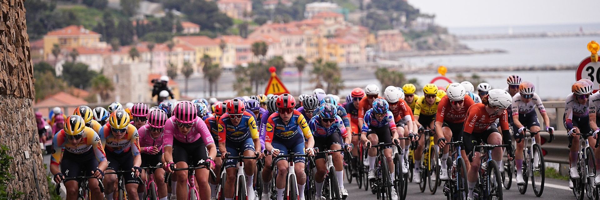 Peloton of women cyclists racing on coastal roads in Sanremo during the Sanremo Women one-day race.