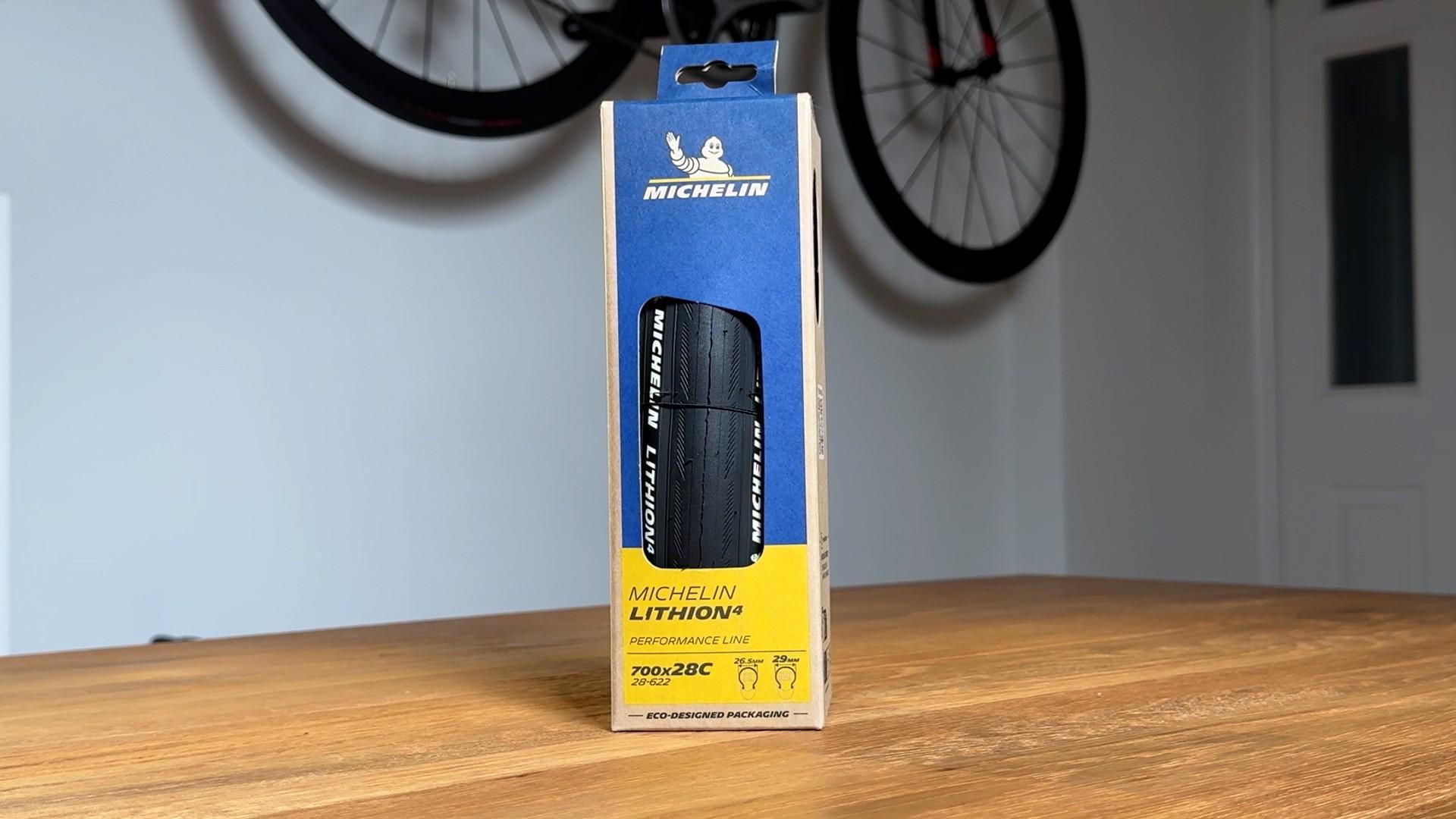 Michelin Lithion road bike tire displayed in its box on a wooden table