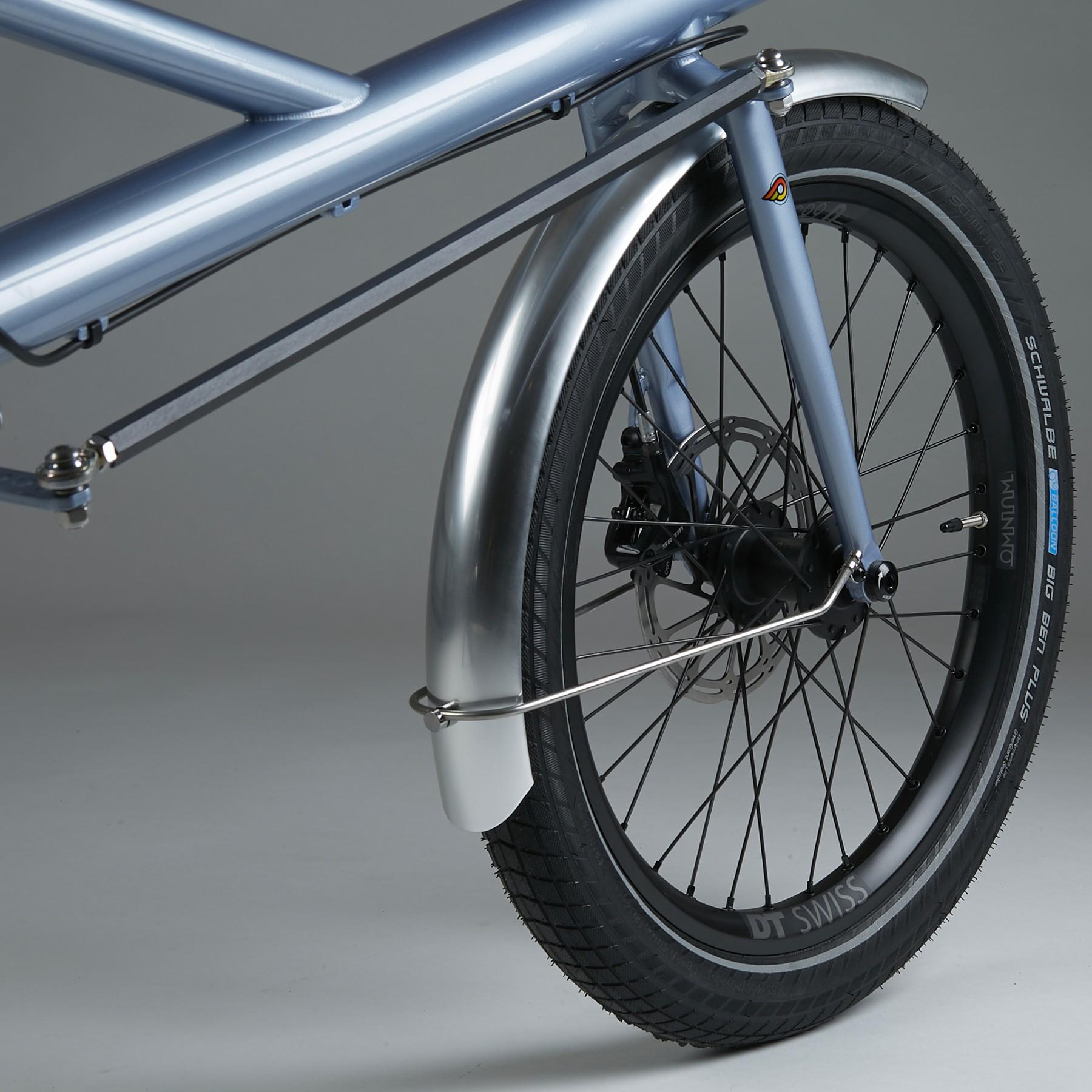 Close-up of a light blue city bicycle wheel and disc brake on a studio background