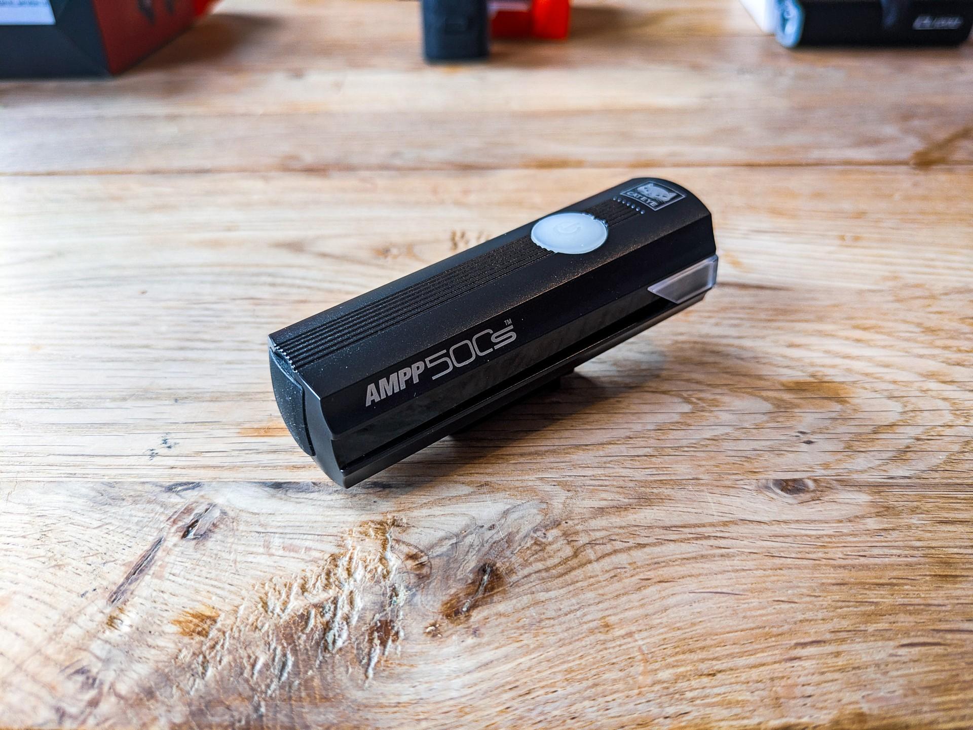 CatEye AMPP 500S front light resting on a wooden table