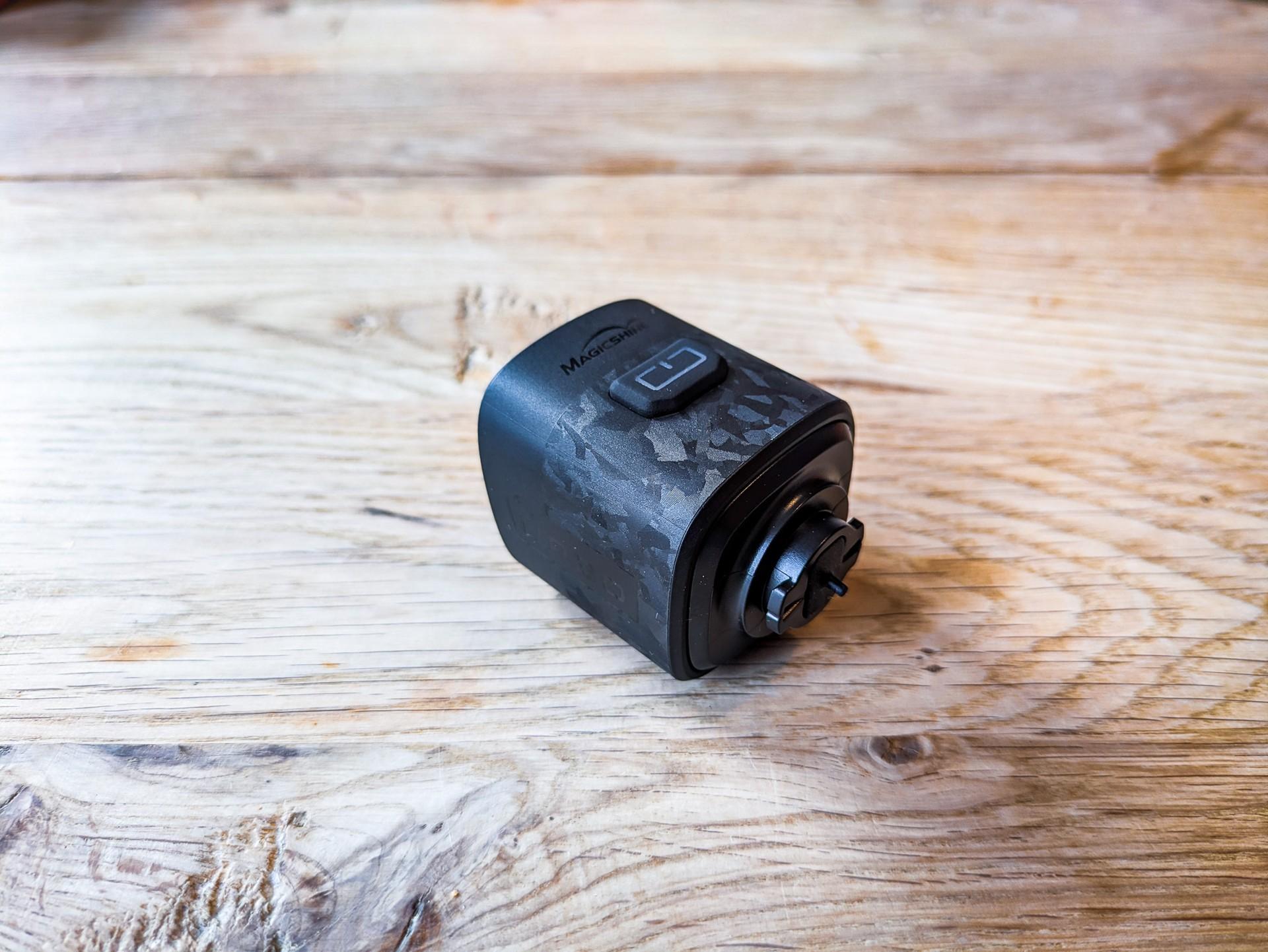 Magicshine URBO FL front bike light resting on a wooden tabletop