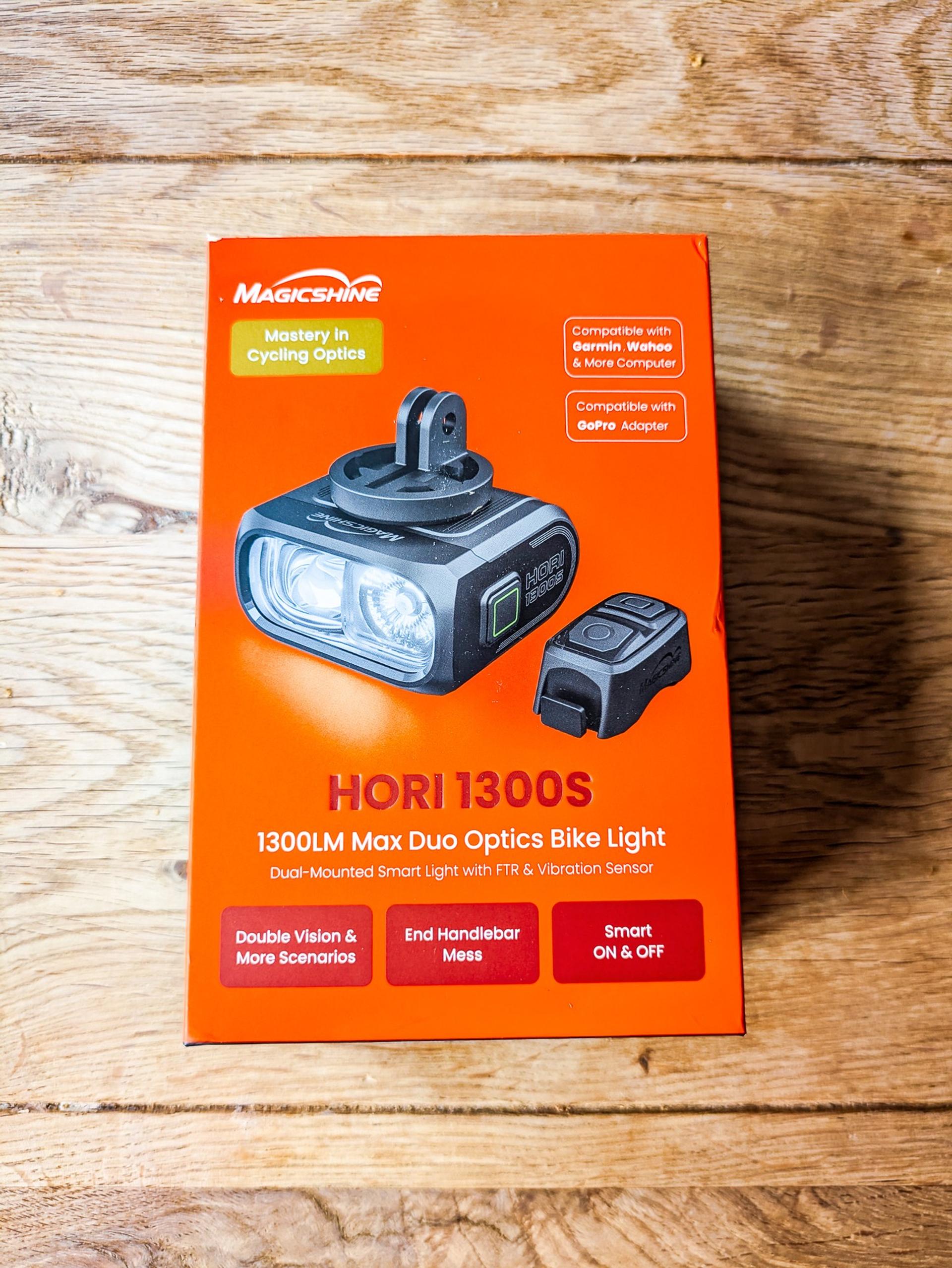 Magicshine HORI 1300 bike light box showing the front light, wireless remote and dual-mount features