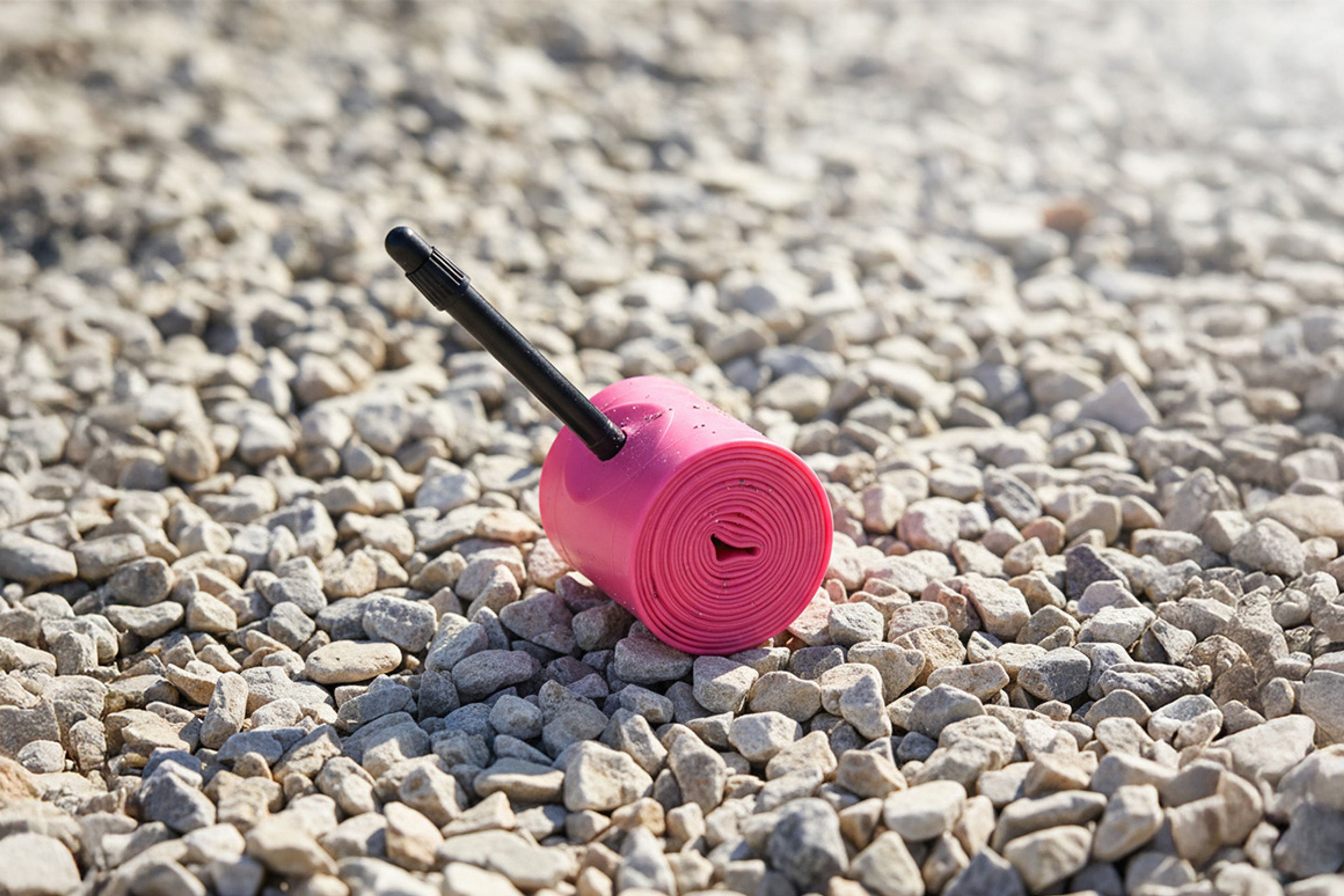 RideNow Race Formula TPU inner tube on a bright gravel background