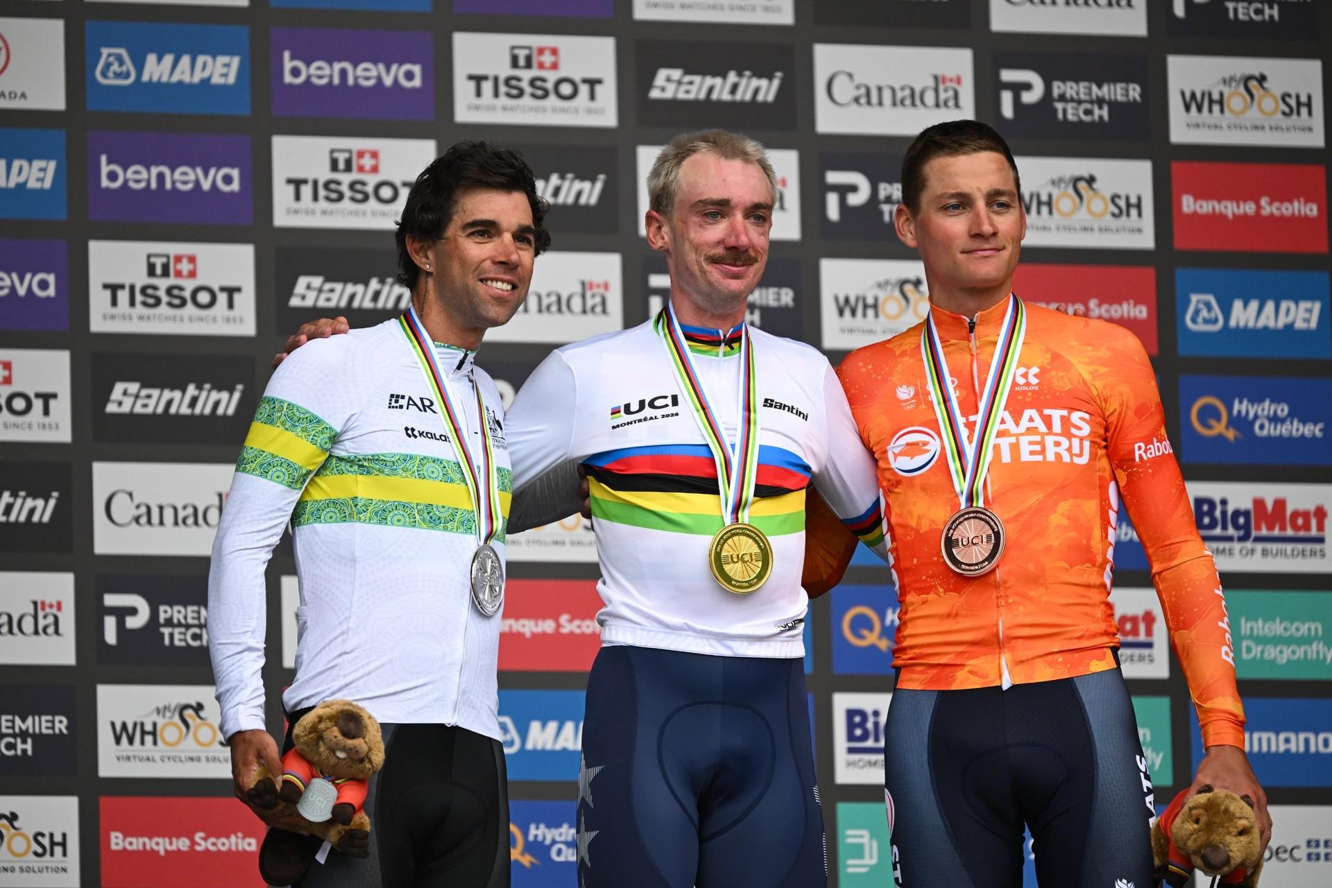 Brandon McNulty, Michael Matthews and Mathieu van der Poel pose with their medals in front of a sponsor backdrop.