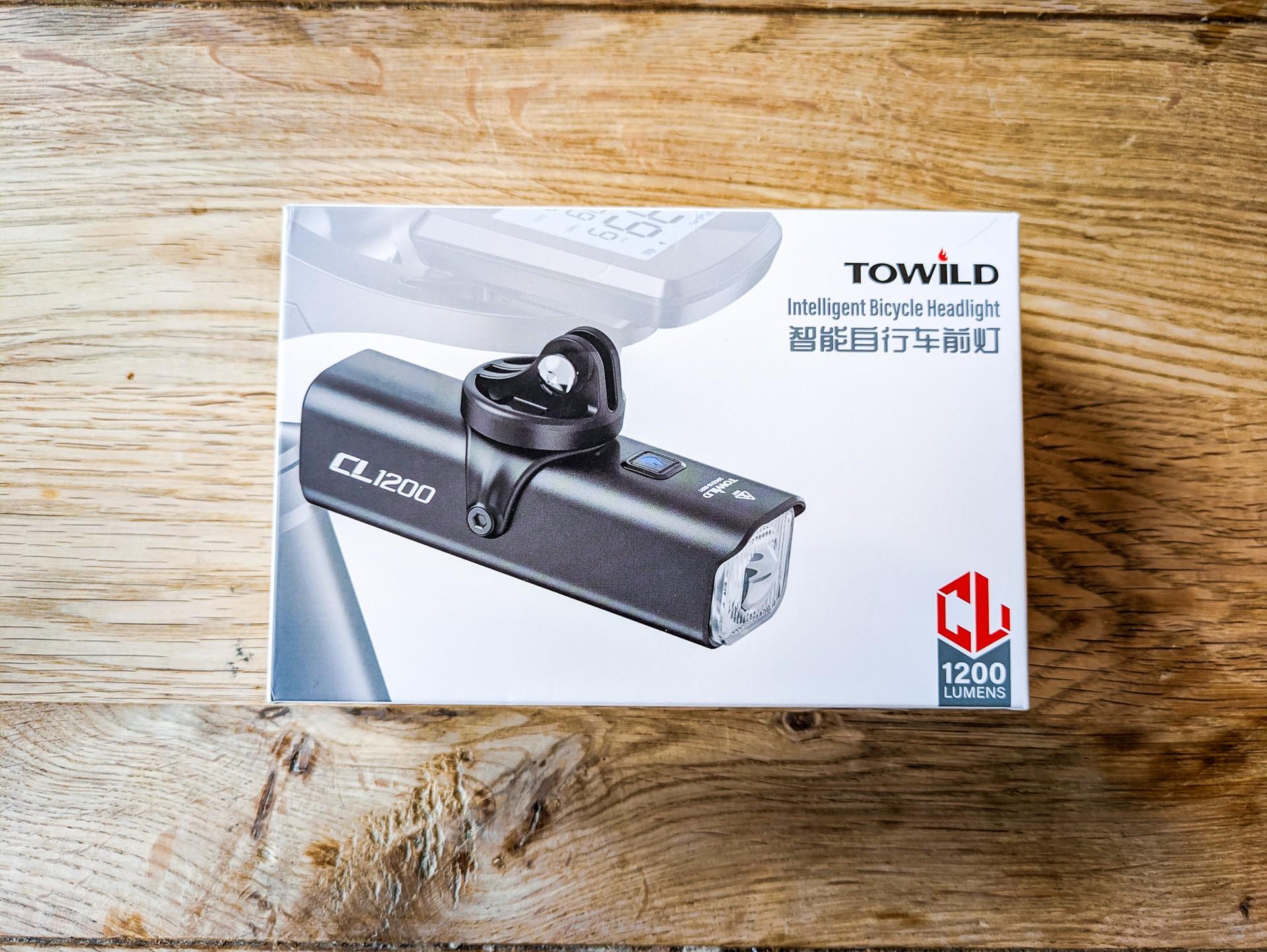 Towild CL1200 intelligent bicycle headlight box resting on a wooden surface