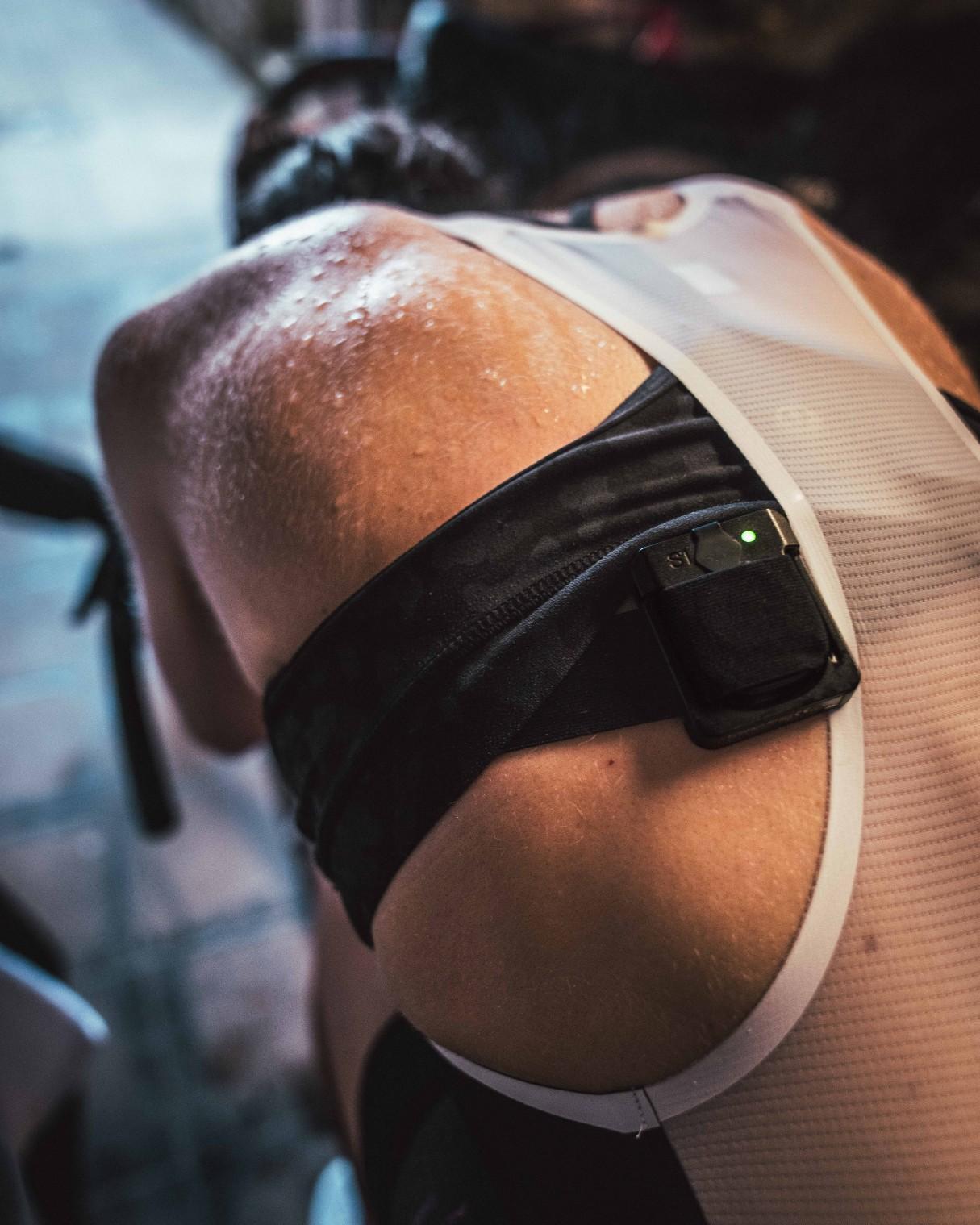 Cyclist in padded shorts adjusting knee pads or cycling braces during a ride