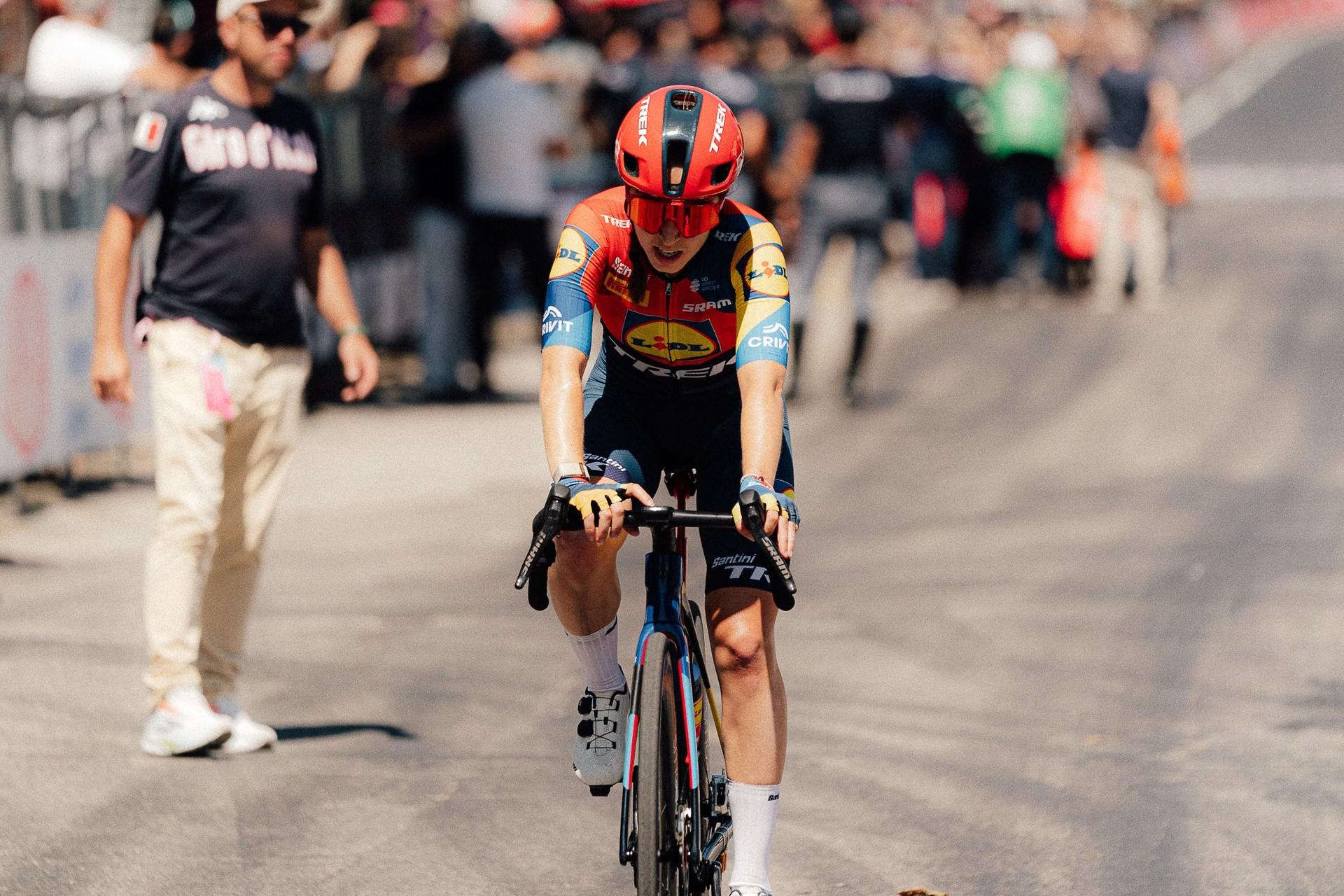 Shirin van Anrooij rides a road bike indoors, wearing a red helmet and Lidl-Trek team kit.