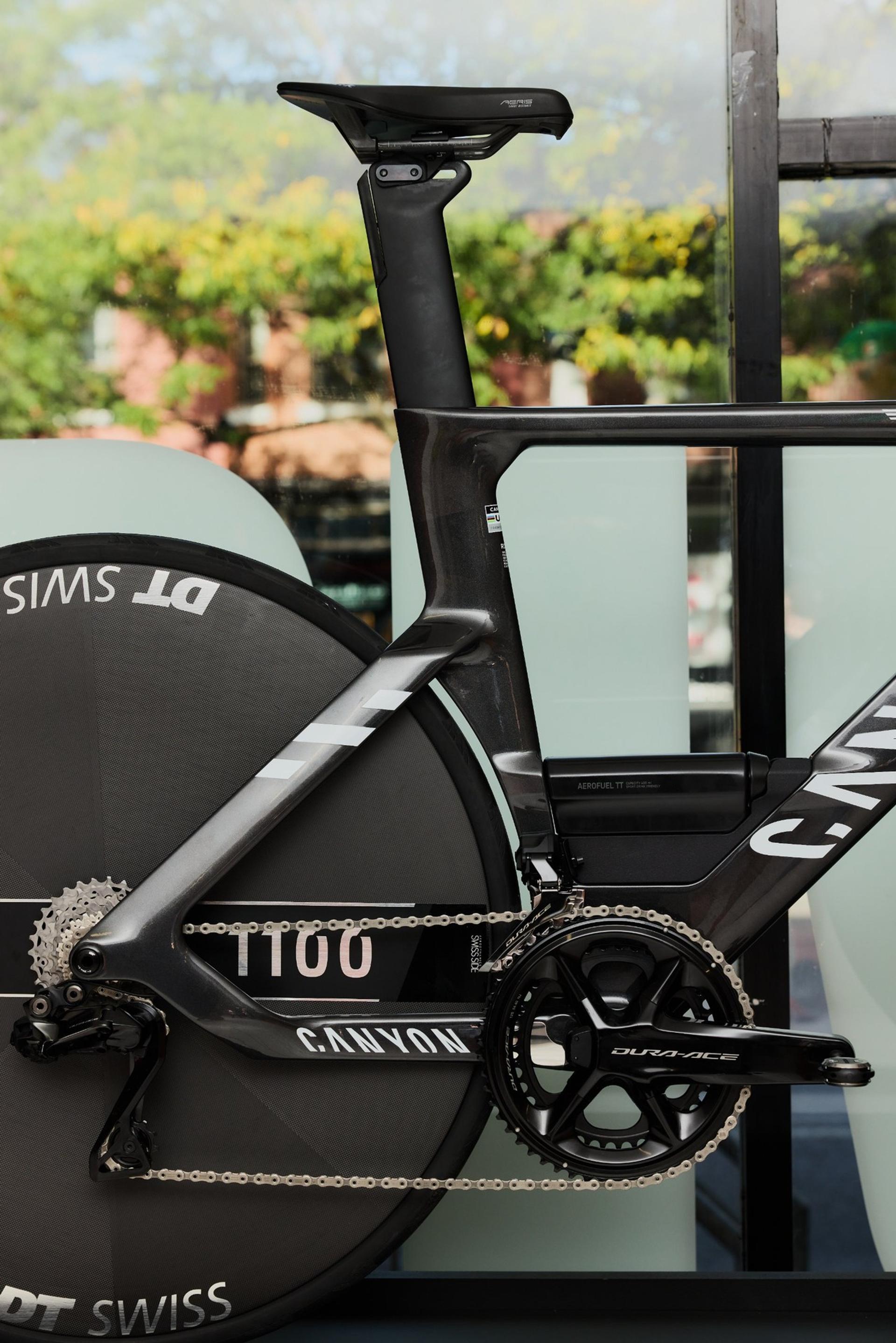 Close-up of Canyon’s unreleased Speedmax CFR TT prototype, showing its aero frame, seatpost, chain and deep-section wheels.