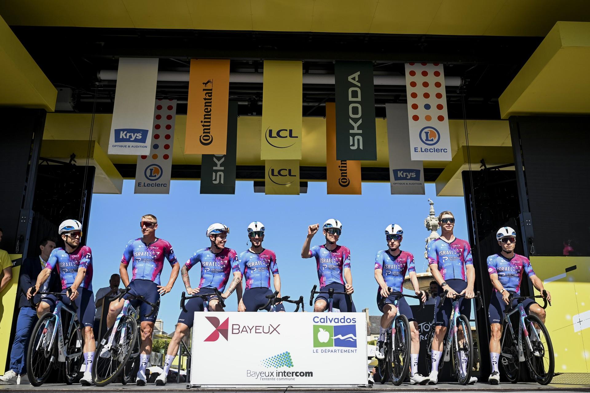 Israel-Premier Tech team pre-race lineup with sponsor logos on jerseys.