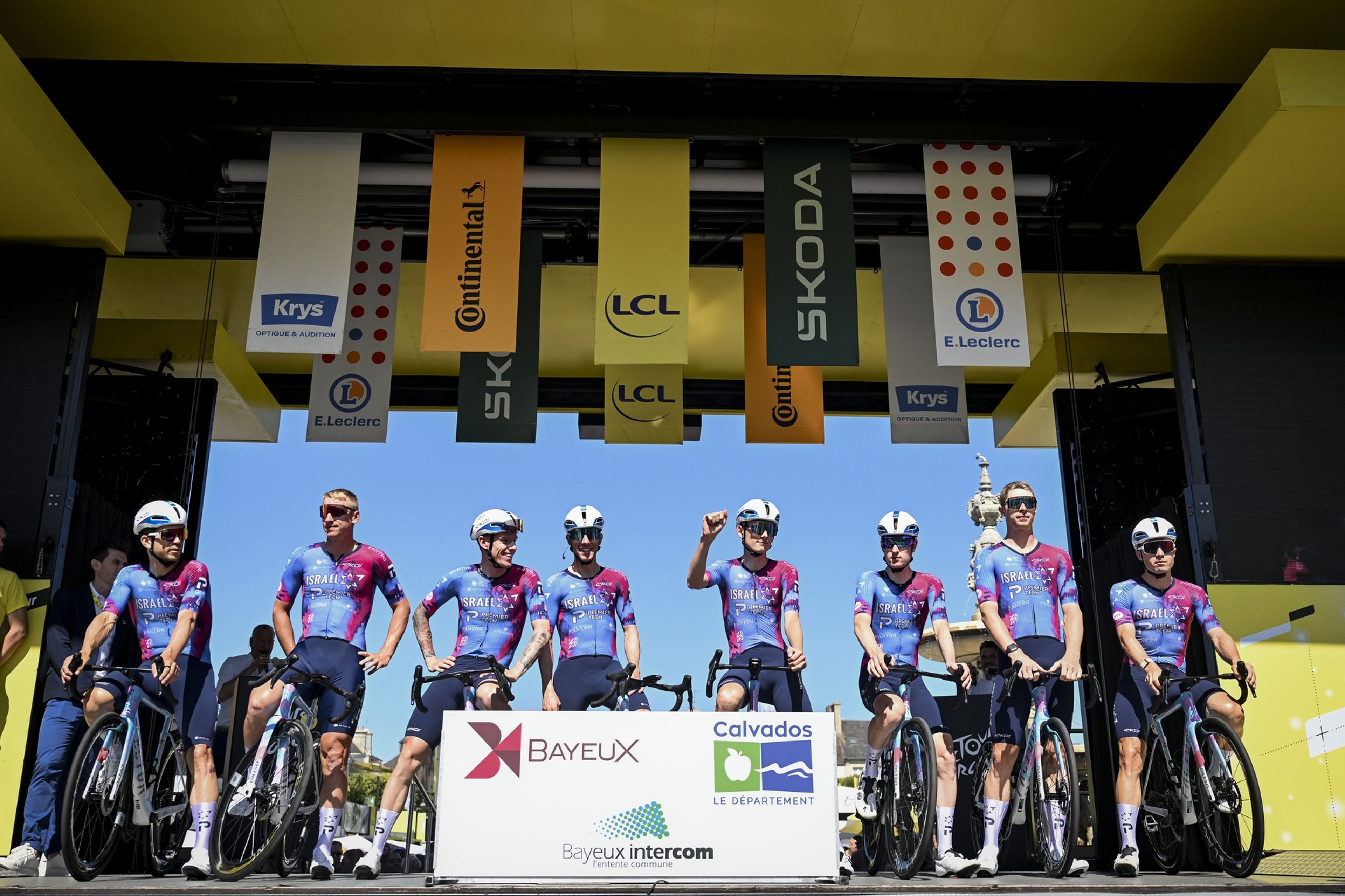 Israel-Premier Tech team pre-race lineup with sponsor logos on jerseys.