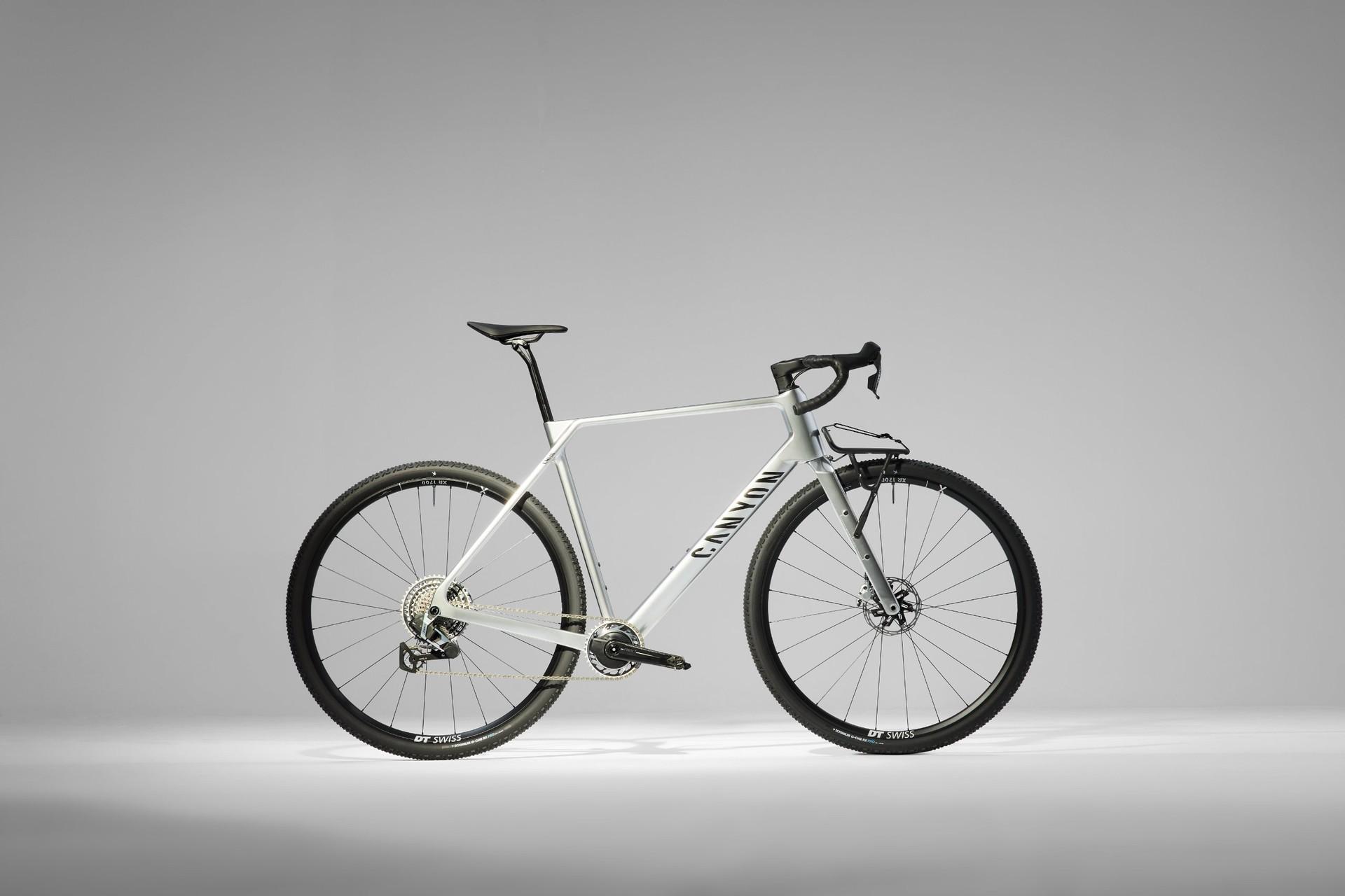 White Canyon Grizl gravel bike with 32-inch wheels displayed in profile against a gray studio background