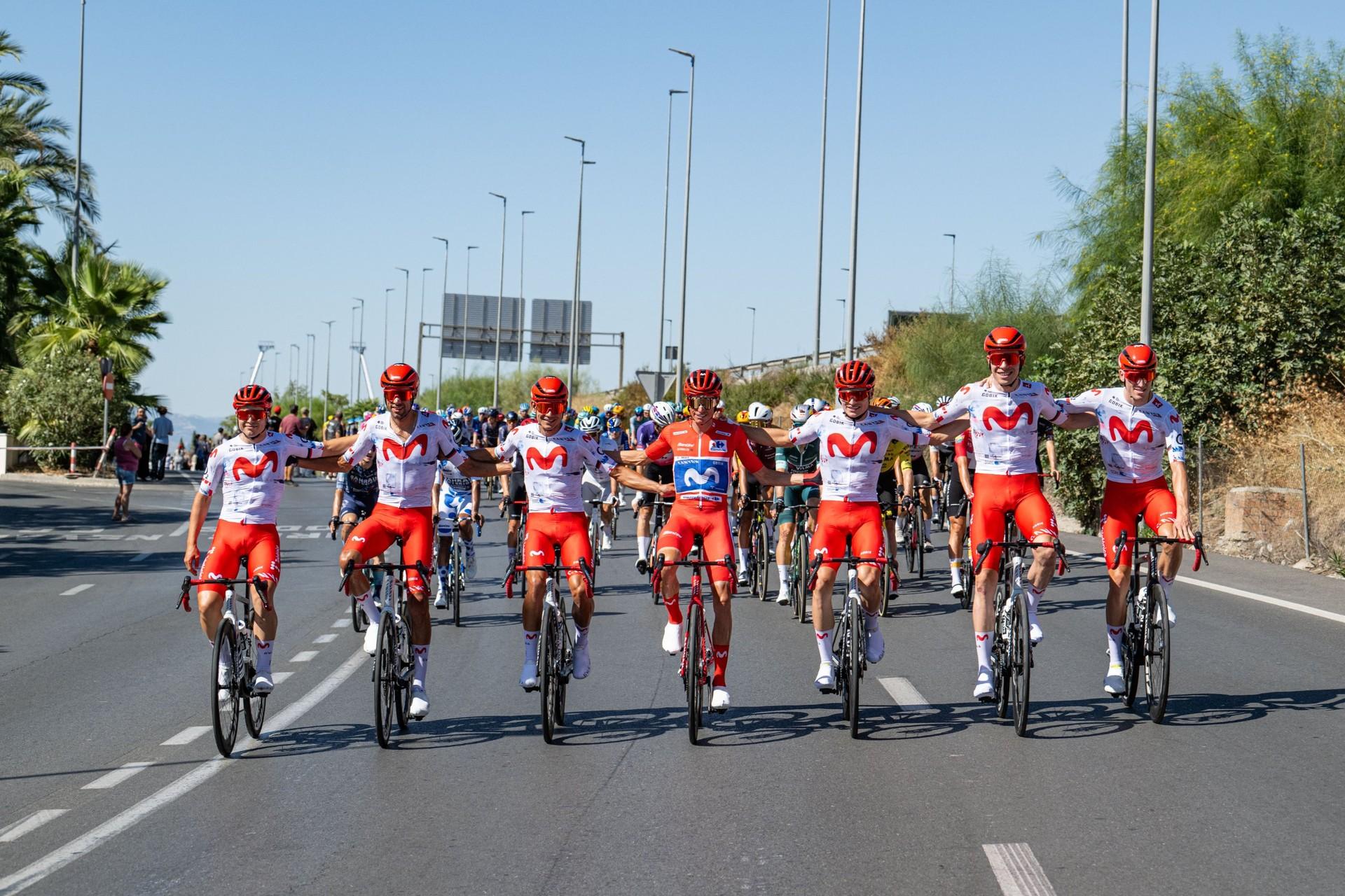 Enric Mas and Movistar teammates ride together on a sunlit road during the Vuelta a España.