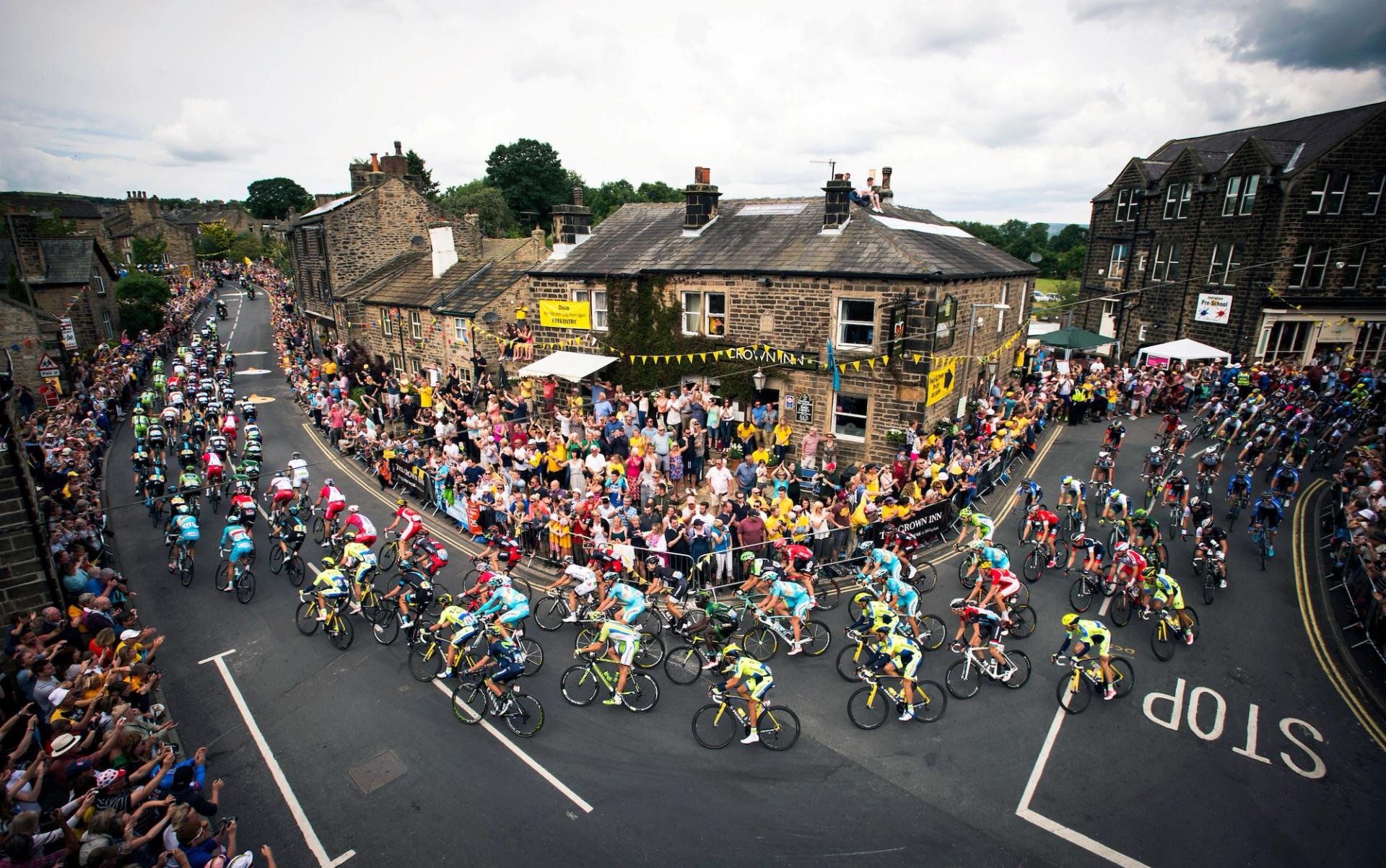Picture by Allan McKenzie/SWpix.com - 06/07/2014 - Cycling - Yorkshire Grand Depart of the Tour de France 2014 - Stage 2, York to Sheffield - Yorkshire, England - The peloton Passes through the Wharfedale village of Addingham, West Yorkshire, for the second time in Le Tour
