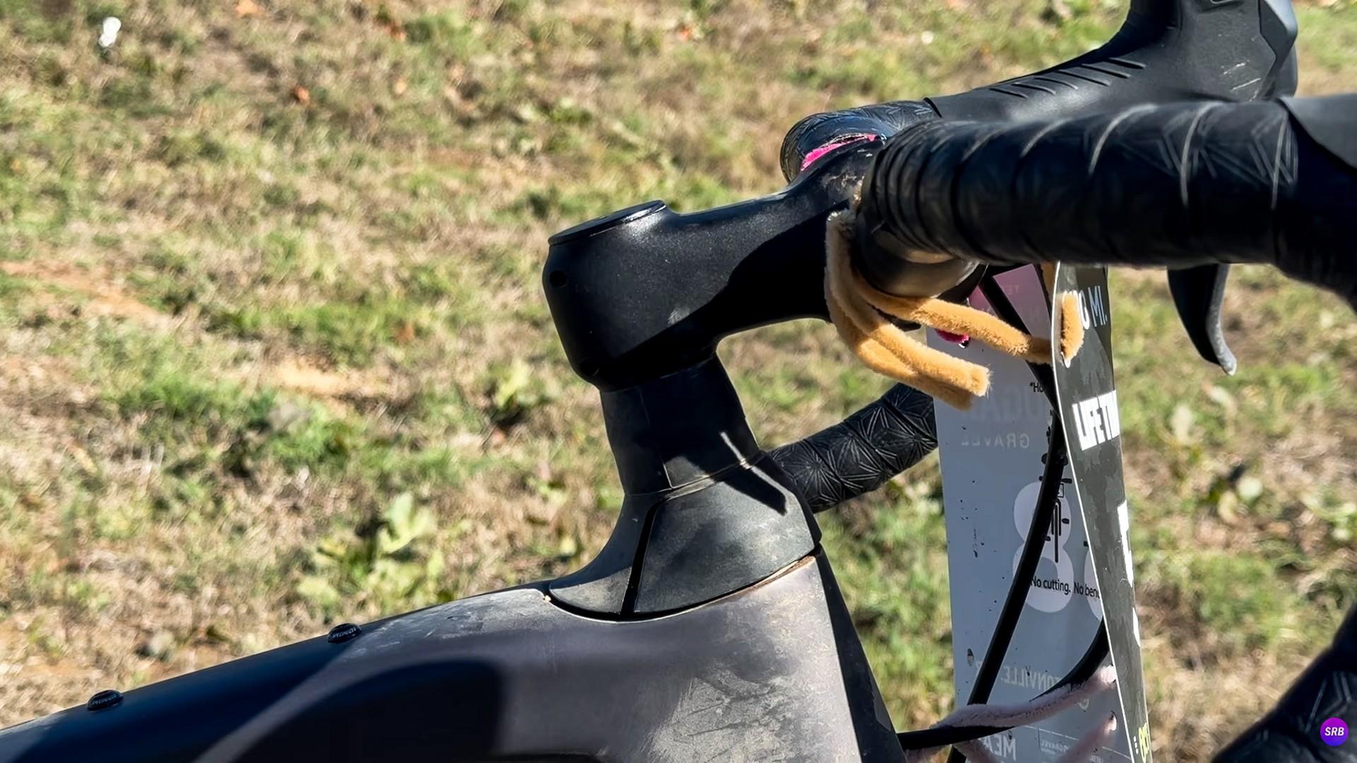 Close-up of a cyclist’s gloved hand gripping a road bike’s brake hood outdoors