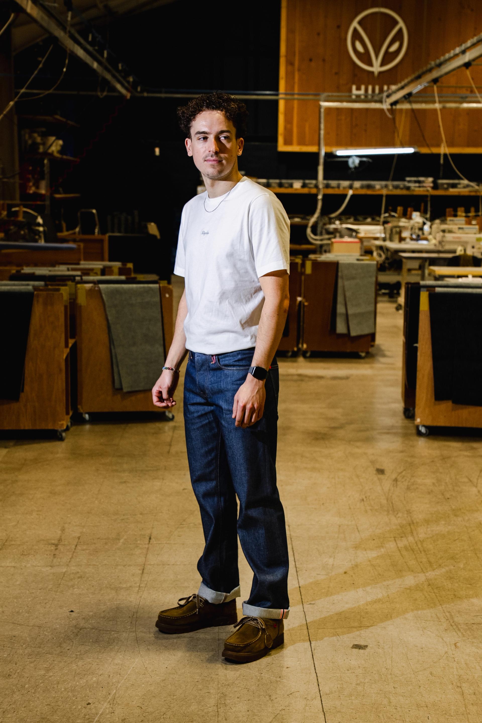 Man stood wearing Hiut jeans in a factory