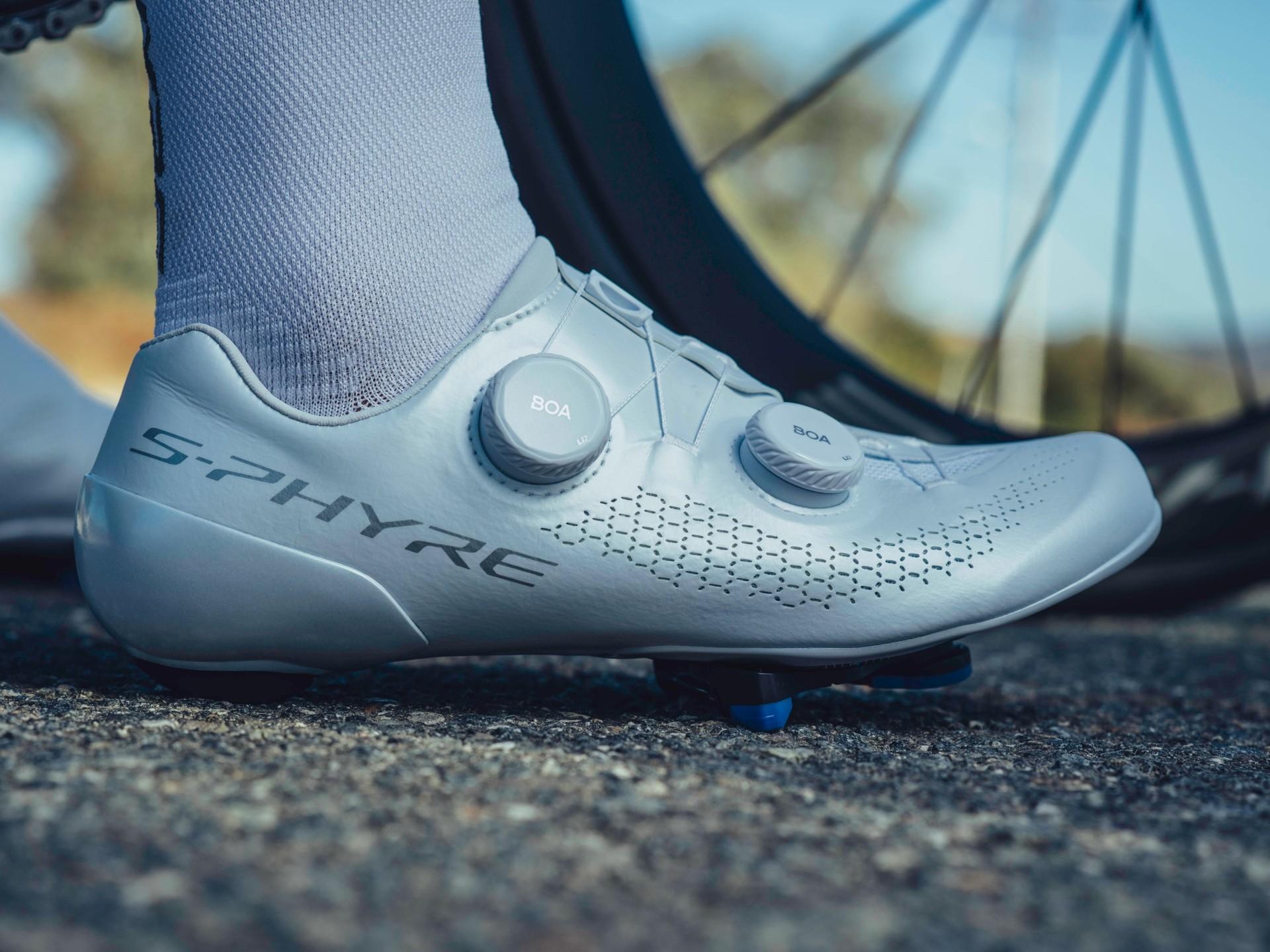 Close-up of a light blue Specialized cycling shoe with a dial closure, pictured against a blurred background.