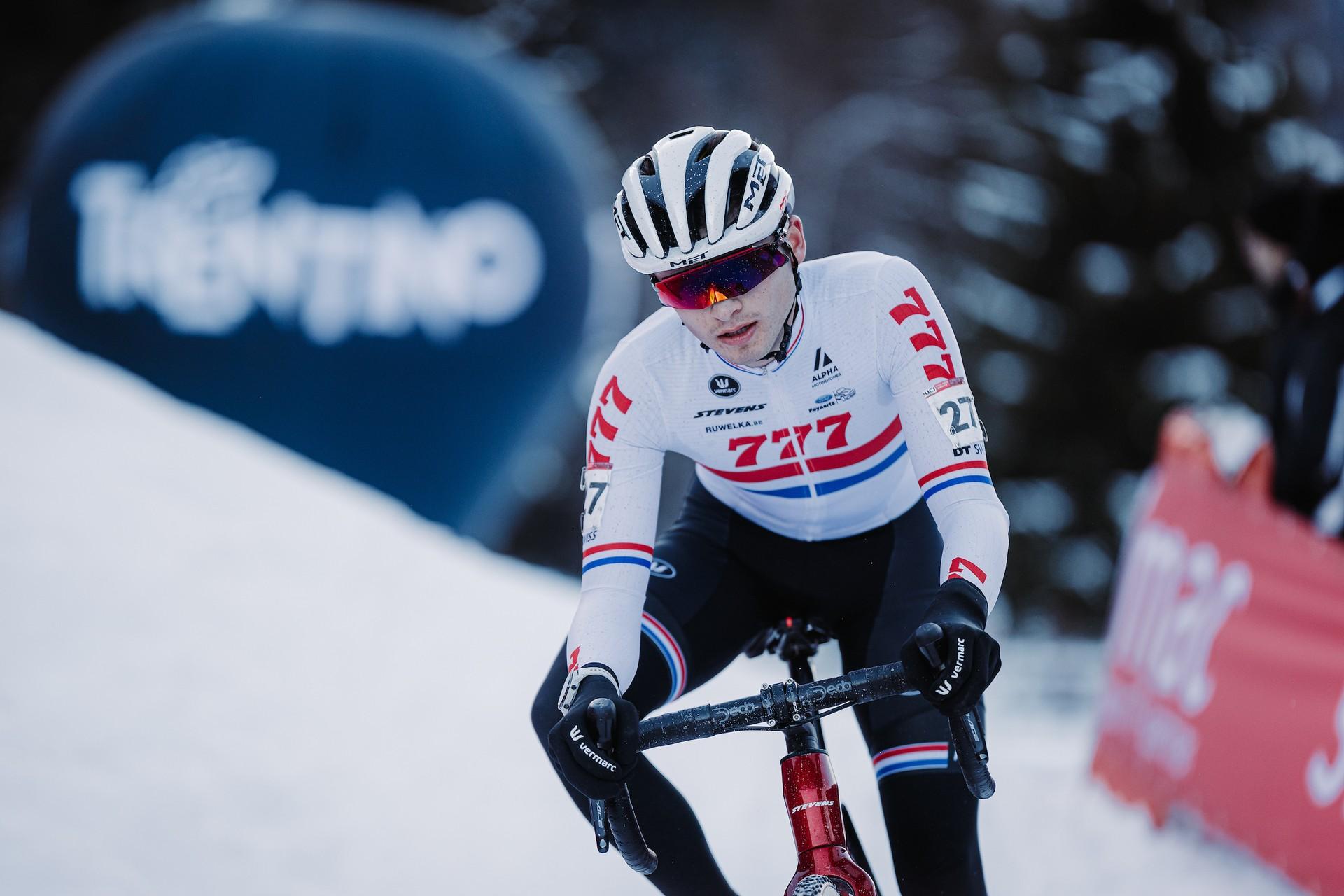 Cameron Mason competing in the UCI Cyclo-cross World Cup on a snow-covered track in Val di Sole, Italy.