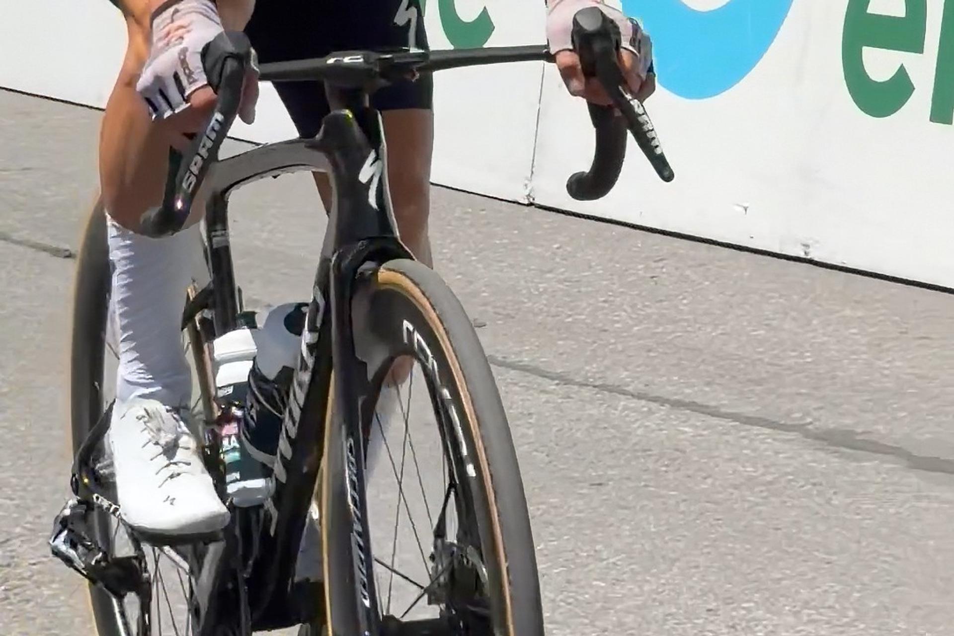 Cyclist’s road bike on paved race course during a sprint, hands on handlebars